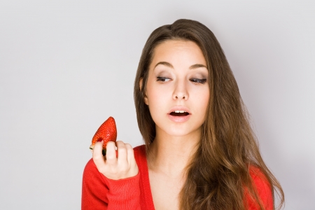 Portrait of grogeous healthy happy young woman with fresh strawberries の写真素材