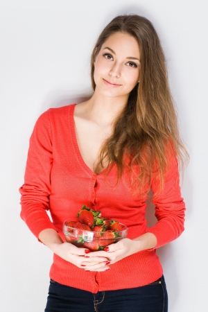 Portrait of serene brunette beauty with fresh ripe strawberries の写真素材