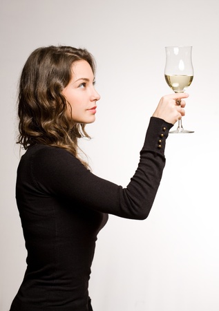 Portrait of a gorgeous young brunette woman enjoying premium wine の写真素材