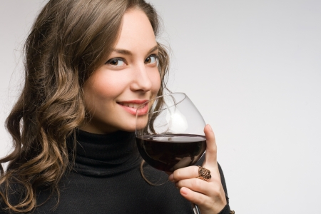 Cool fashionable young brunette woman tasting great wine の写真素材