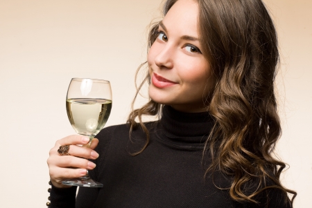 Portrait of a gorgeous young brunette woman enjoying premium wine の写真素材