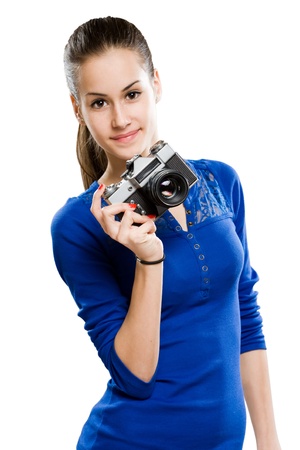 Smiling slender attractive young brunette holding photo camera, isolated on white background.の写真素材