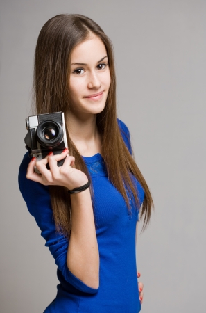 Portrait of a beautiful young brunette with photo camera.の写真素材