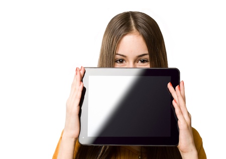 Portrait of a gorgeous teen girl having fun with tablet computer.の写真素材