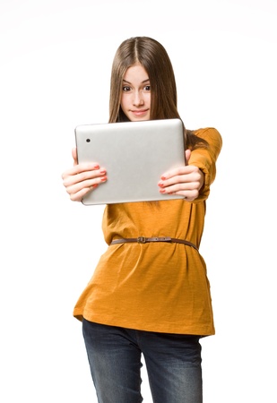 Portrait of a cute cool teen girl using tablet device.の写真素材