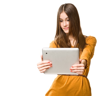 Portrait of beautiful brunette teen using tablet computer.の写真素材