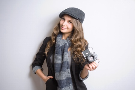 Portrait of very fashionable young brunette with retro film camera の写真素材