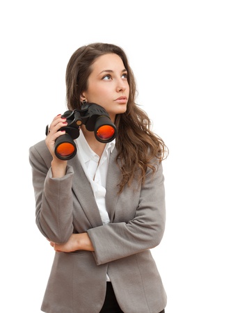 Portrait of a beautiful young brunette businesswoman with seeking with binoculars の写真素材