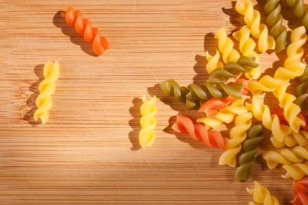 Shot of colorful italian pasta drenched in natural sunlight on cutting board の写真素材