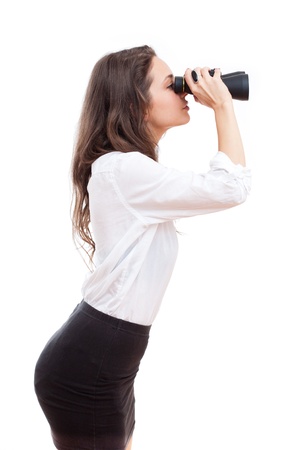 Portrait of brunette beauty holding binoculars isolated on white background.の写真素材