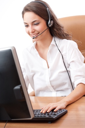 Beautiful young brunette woman in offfice wearing headset.の写真素材
