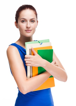 Portrait of attractive young student with colorful exercise books and folders.の写真素材