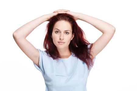 Portrait of a beautiful young redhead woman on white background.の写真素材