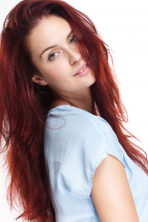 Portrait of a beautiful young redhead woman on white background.の写真素材
