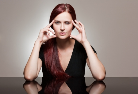 Portrait of a redhead beauty with strong facial expression.