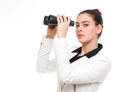 Portrait of an elegant fashionable businesswoman holding binoculars.の写真素材