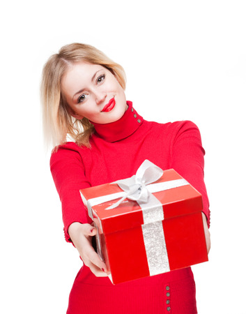 Portrait of a beautiful young blond woman holding shiny red gift box.の写真素材