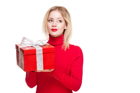 Portrait of a cute young blond with bright red gift box.の写真素材