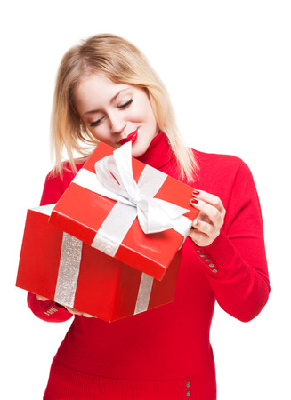 Gorgeous cute young blond woman holding bright red present box.の写真素材
