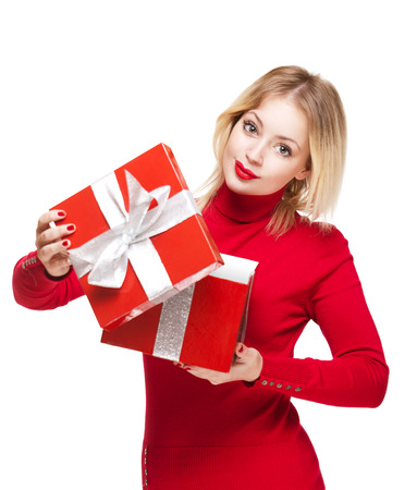 Gorgeous cute young blond woman holding bright red present box.の写真素材