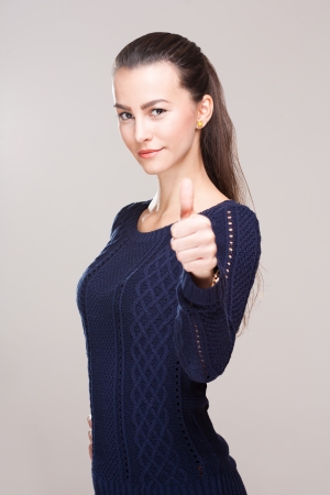 Gorgeous young brunette woman showing thumbs up.の写真素材