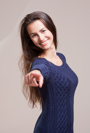Portrait of a happy brunette woman in blue sweater.の写真素材