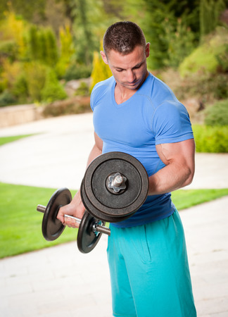 Outdoors portrait of a very strong and healthy young man.の写真素材