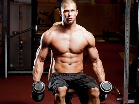 Portrait of a muscular strong young man working out.の写真素材