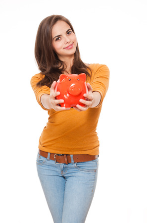 Portrait of an attractive young brunette with piggy bank.の写真素材