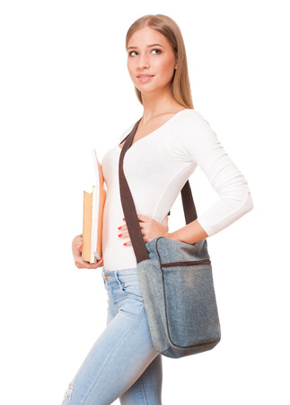 Portrait of a gorgeous blond student girl isolated on white background.の写真素材