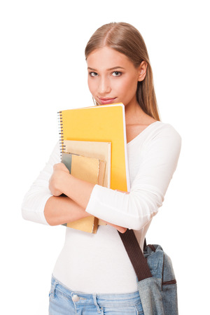 Portrait of an attractive young student with exercise books.の写真素材