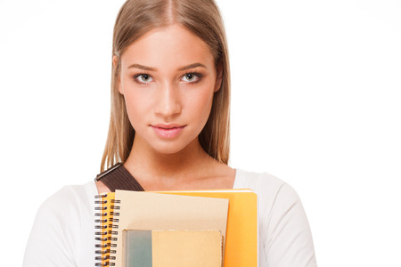 Portrait of a gorgeous blond student girl isolated on white background.の写真素材