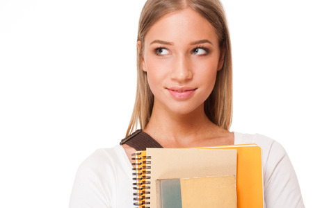 Portrait of an attractive young student with exercise books.の写真素材