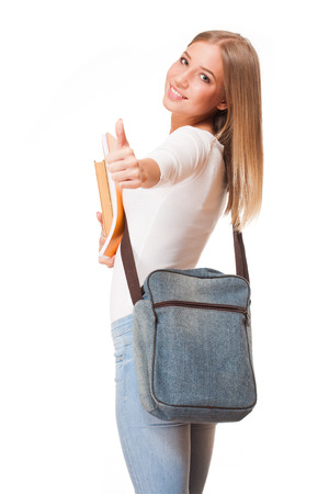 Portrait of a gorgeous blond student girl isolated on white background.の写真素材