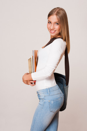 Portrait of an attractive young student with exercise books.の写真素材