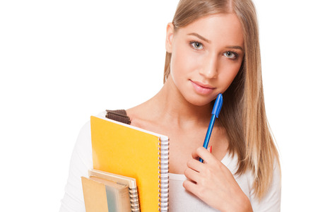 Portrait of a gorgeous blond student girl isolated on white background.の写真素材