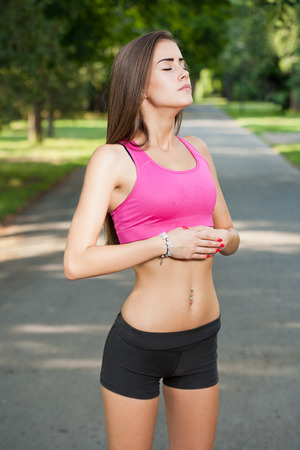 Portrait of a beautiful fit teen girl outdoors in the park.の写真素材