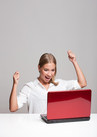 Portrait of a young blond beauty with her laptop.の写真素材