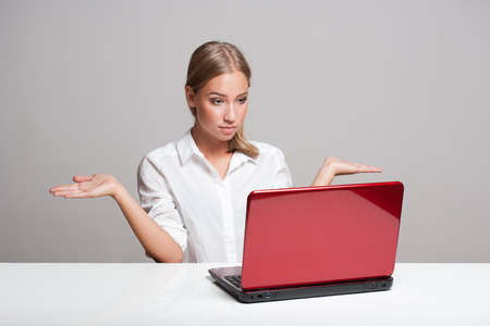 Portrait of a young blond beauty with her laptop.の写真素材