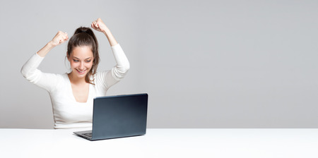 Portrait of a young brunette beauty with her laptop.の写真素材