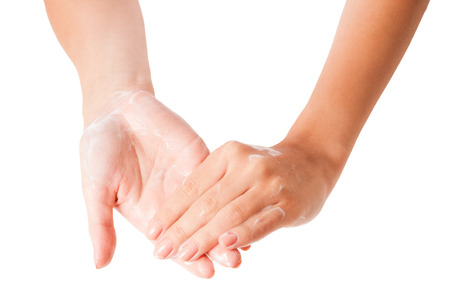 Female hands applying body lotion on white background.の写真素材