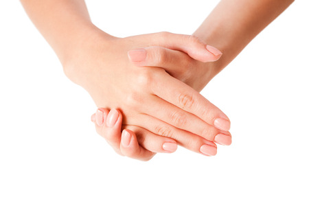 Female hands using body lotion, isolated on white background.の写真素材