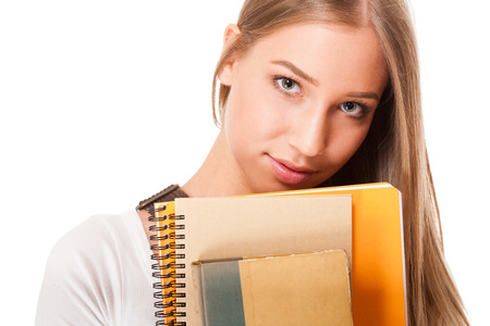 Portrait of a blond attractive young student with exercise books.の写真素材
