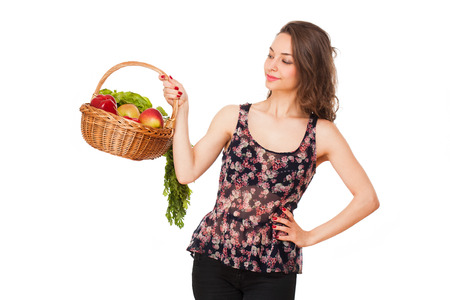 Gorgeous young brunette woman holding a basket of healthy food.の写真素材