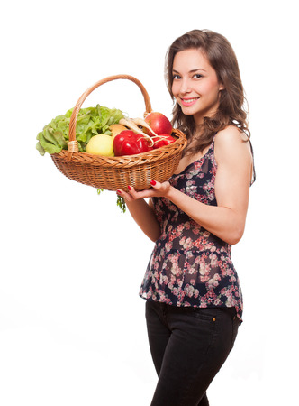 Gorgeous young brunette woman holding a basket of healthy food.の写真素材