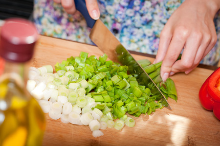 Gorgeous young brunette woman in the kitchen preparing healthy ingredients.の写真素材