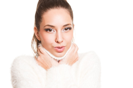 Gorgeous young brunette woman dressed in all white warm clothes.の写真素材