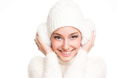 Cool brunette beauty in all white winter clothing.の写真素材