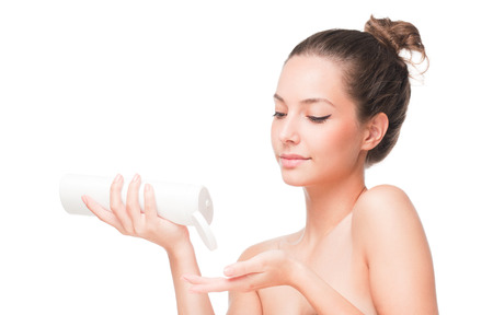 Portrait of a young brunette cosmetics beauty on white background.の写真素材