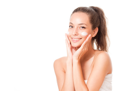 Portrait of a young brunette cosmetics beauty on white background.の写真素材